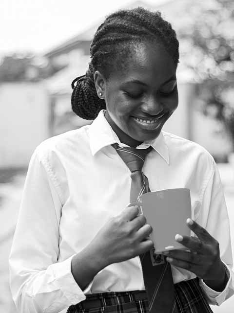 Young Lady looking into a cup of clean drinking water